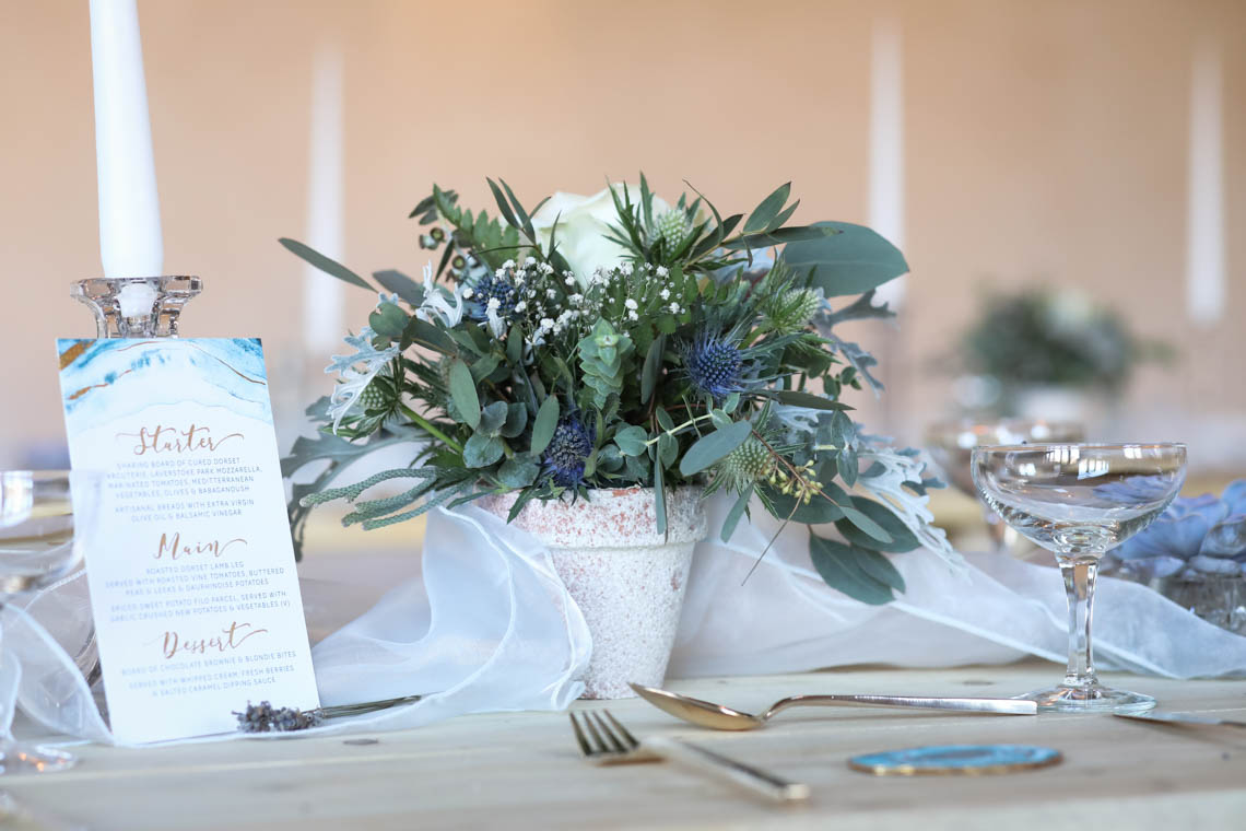 Menu and floral display on table | Journey to the Centre of the Earth | modern ethereal winter styled bridal shoot by Hanami Dream | agate | marble | airplants | tulle | pale blue | gold | Oxleaze Barn | Gloucestershire | October 2017 | Photography by Squib Photography www.squibphotography.co.uk