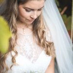 Bride looking at bouquet in the garden | Journey to the Centre of the Earth | modern ethereal winter styled bridal shoot by Hanami Dream | agate | marble | airplants | tulle | pale blue | gold | Oxleaze Barn | Gloucestershire | October 2017 | Photography by Squib Photography www.squibphotography.co.uk