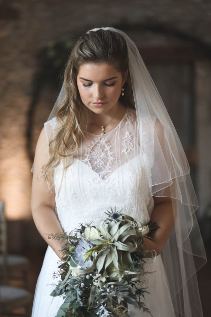 Bride looking down in front of moongate | Journey to the Centre of the Earth | modern ethereal winter styled bridal shoot by Hanami Dream | agate | marble | airplants | tulle | pale blue | gold | Oxleaze Barn | Gloucestershire | October 2017 | Photography by Squib Photography www.squibphotography.co.uk