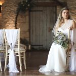 Bride sat on Chivari chair in front of moongate wreath | Journey to the Centre of the Earth | modern ethereal winter styled bridal shoot by Hanami Dream | agate | marble | airplants | tulle | pale blue | gold | Oxleaze Barn | Gloucestershire | October 2017 | Photography by Squib Photography www.squibphotography.co.uk