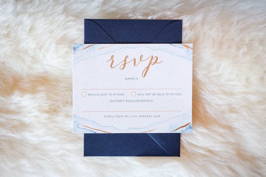 RSVP card on sheep skin rug | Journey to the Centre of the Earth | modern ethereal winter styled bridal shoot by Hanami Dream | agate | marble | airplants | tulle | pale blue | gold | Oxleaze Barn | Gloucestershire | October 2017 | Photography by Squib Photography www.squibphotography.co.uk
