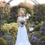 Bridesmaid under arch in garden | Journey to the Centre of the Earth | modern ethereal winter styled bridal shoot by Hanami Dream | agate | marble | airplants | tulle | pale blue | gold | Oxleaze Barn | Gloucestershire | October 2017 | Photography by Squib Photography www.squibphotography.co.uk